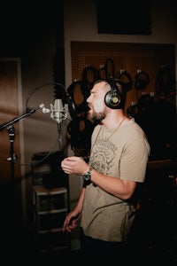 a man wearing headphones in a recording studio